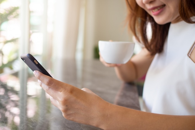 Smiling woman using a smartphone