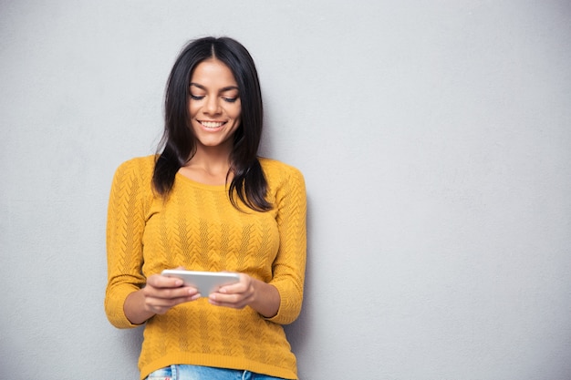 Smiling woman using smartphone