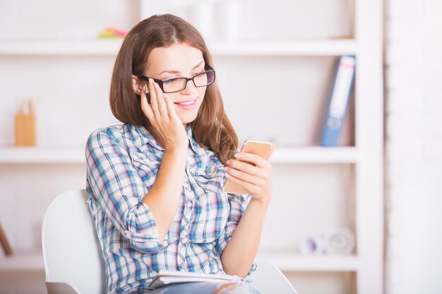 Smiling woman using smartphone