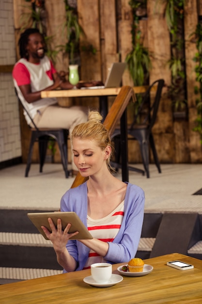 Smiling woman using a tablet