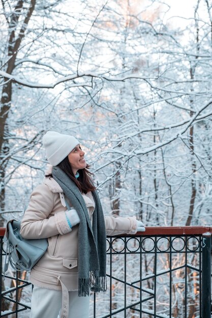 Smiling woman walking by winter park