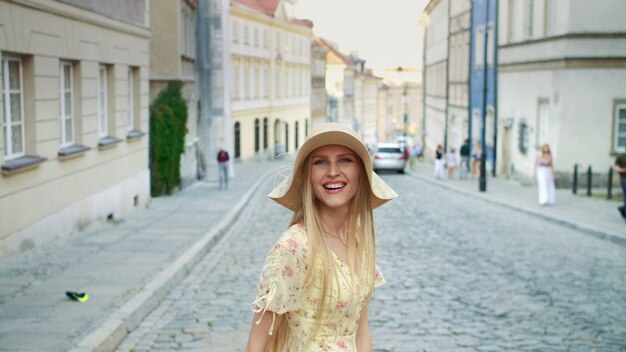 Smiling woman walking on street.