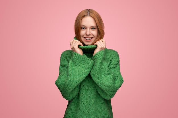 Smiling woman in warm sweater in studio