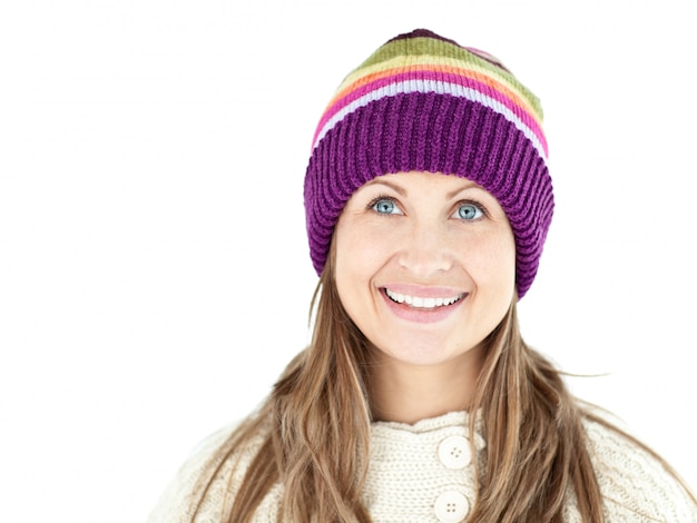 Smiling woman wearing a cap and pullover 