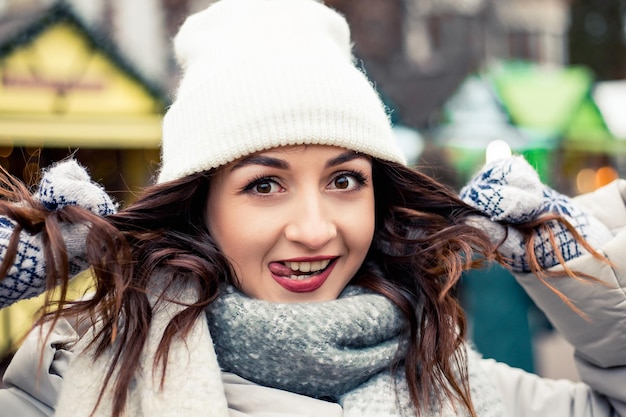 Smiling woman at winter fair making faces