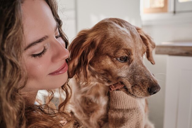 Smiling woman with dog in room