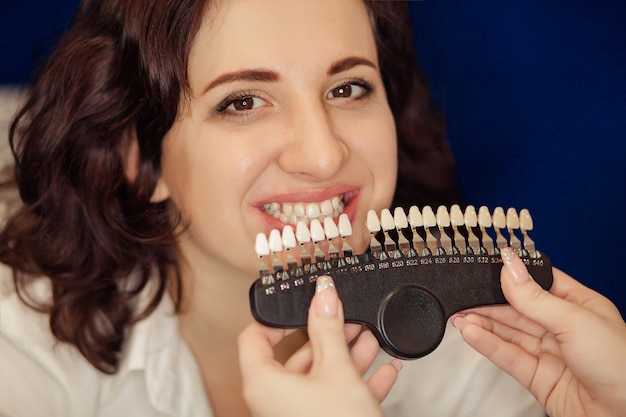 Smiling woman with healthy teeth whitening. Dental care concept.