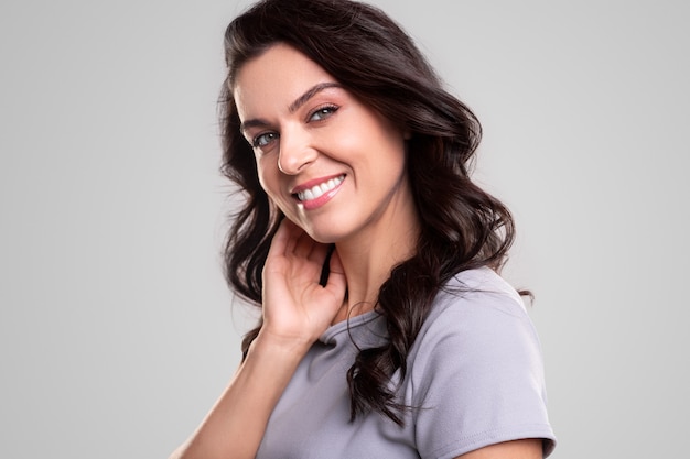 Smiling woman with makeup looking at camera