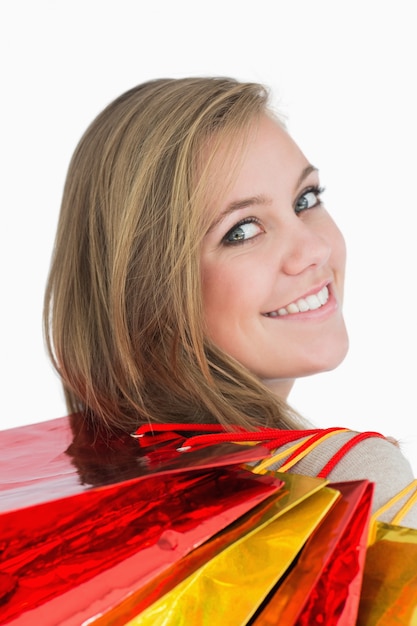 Smiling woman with many shopping bags