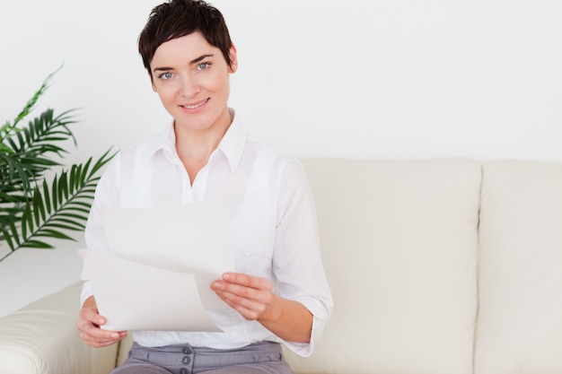 Smiling woman with a paper