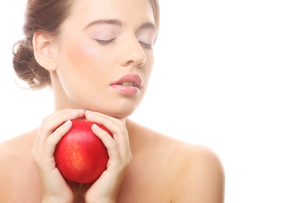 Smiling woman with red apple isolated on white