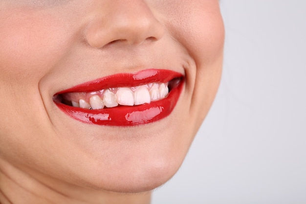 Smiling woman with red lips close-up