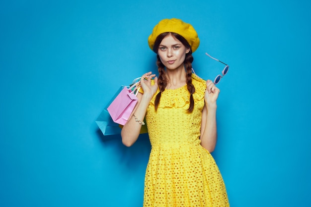 Smiling woman in a yellow hat shopaholic fashion style isolated background