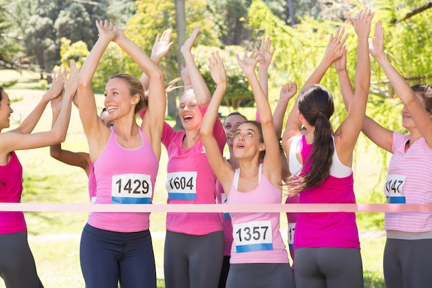 Photo smiling women running for breast cancer awareness