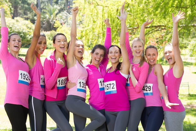 Smiling women running for breast cancer awareness