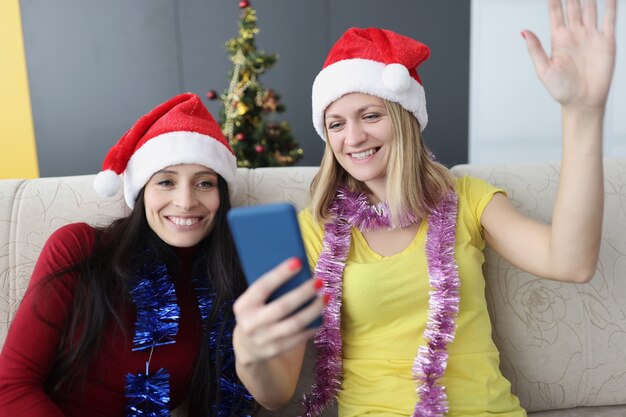 Smiling women sitting on couch