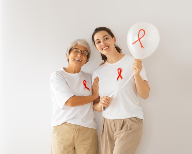 Smiling women with red satin ribbon