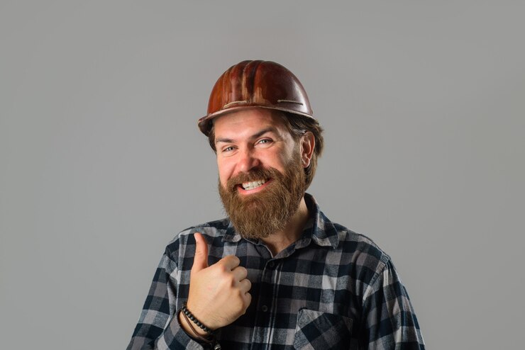  Smiling worker in hard hat shows thumb up construction worker builder concept building industry