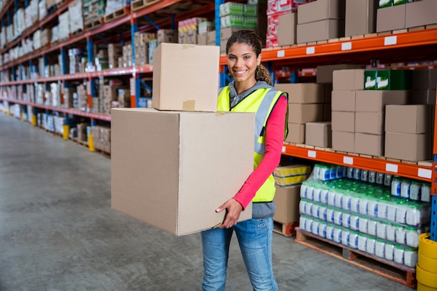 Smiling worker holding boxes