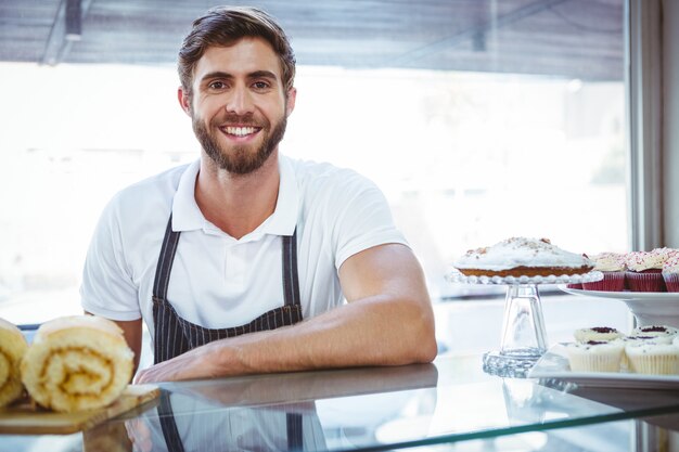  Smiling worker posing behind the counter