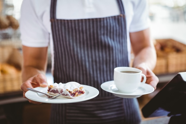 Smiling worker prepares breakfast at the bakery