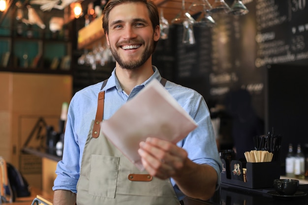 Smiling worker prepares orders at the bakery.