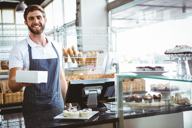 Smiling worker prepares orders 