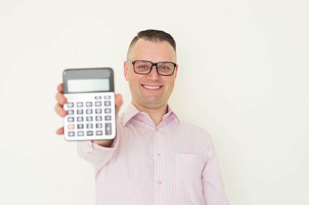 Smiling young accountant demonstrating income figure and showing calculator.