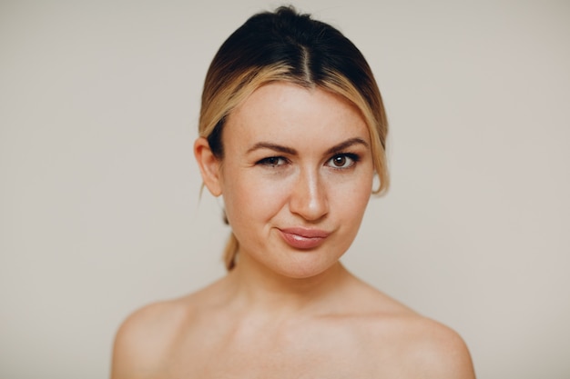 Smiling young adult caucasian woman close up full face portrait with facial expressions