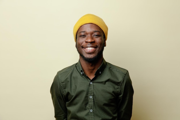 Smiling young african american male in hat wearing green shirt isoloated on white background