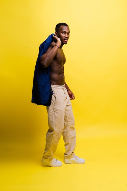 Smiling young african american man guy isolated on yellow background studio people sincere emotions