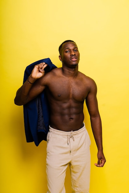 Smiling young african american man guy isolated on yellow background studio People sincere emotions