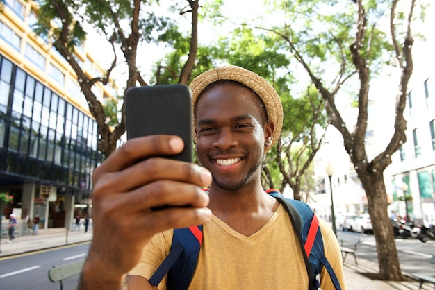 Smiling young african american man taking selfie