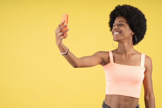 Smiling young Afro woman taking a selfie