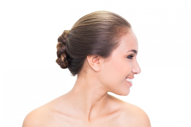 Smiling young brunette woman looking right