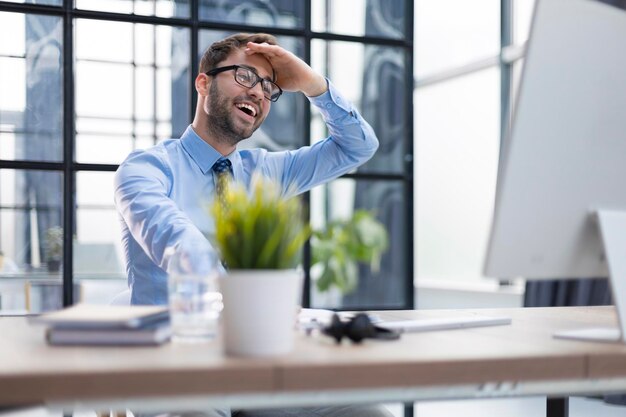 Smiling young business man having video call in office