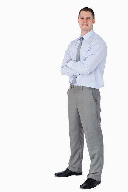 Smiling young businessman with arms folded