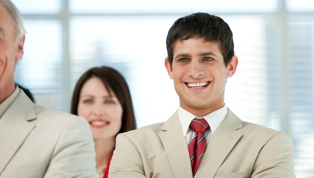 Smiling young businessman with his colleagues