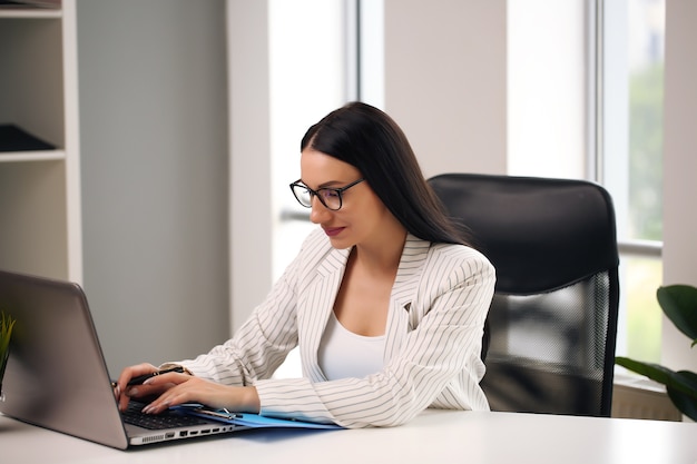 Smiling young businesswoman in office