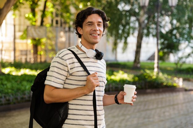 Smiling young casual man drinking coffee