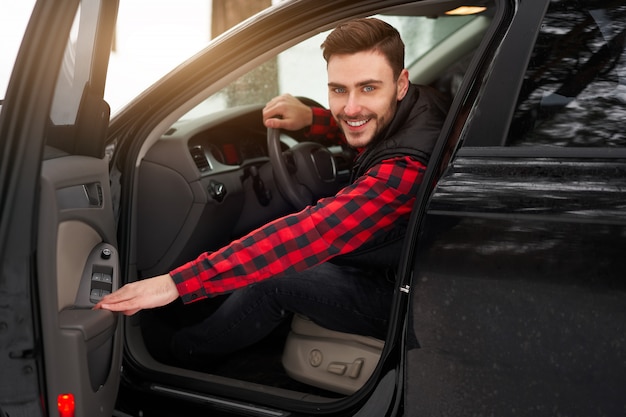 Smiling young caucasian man. Winter. Car driver