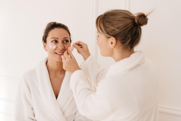 Smiling young caucasian women feel relaxed after spa treatments, enjoy luxury bachelorette party. Skin care and health concept