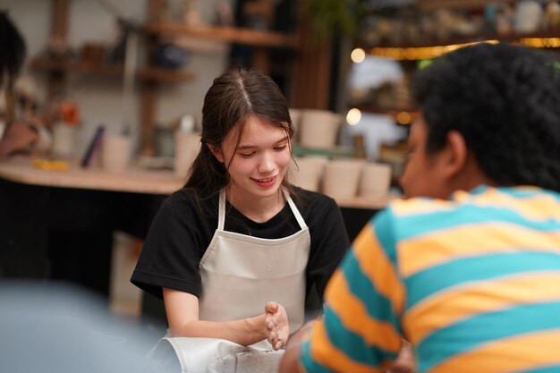 Photo smiling young couple in pottery workshop business owner against shop background