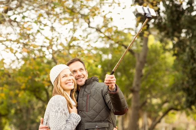 Smiling young couple taking selfies