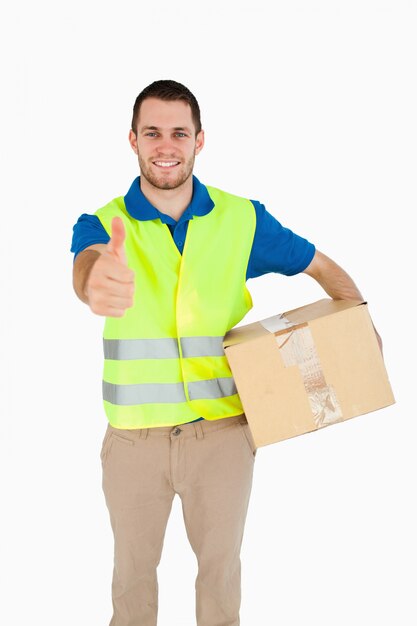 Smiling young delivery man giving approval