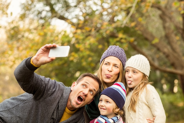 Smiling young family taking selfies