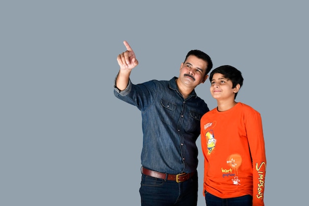Photo smiling young father and son front pose wall indian pakistani model