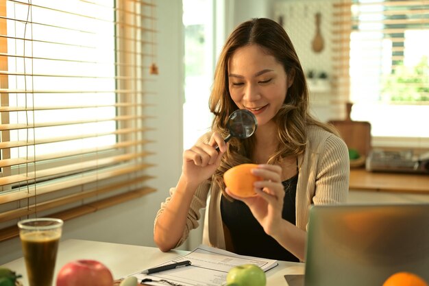 Smiling young female dietitian working on diet plan at office Right nutrition wellness and healthy lifestyle concept