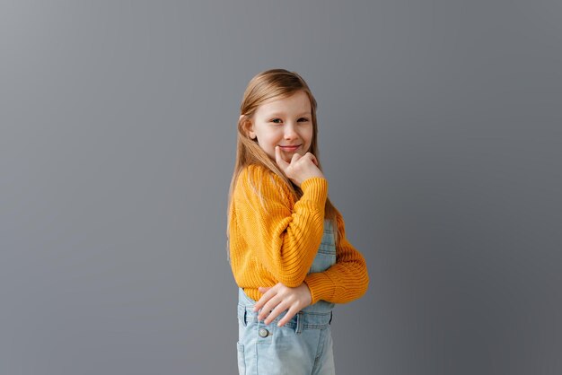 Smiling young girl on the grey background