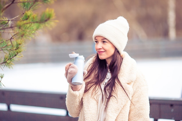 Smiling young girl skating on ice rink outdoors